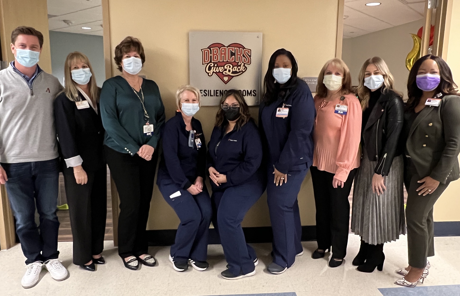 AZ Dbacks board and hospital administrators/nurses stand in front of new Nursing Resilience Rooms