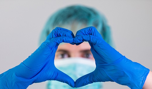 healthcare worker making heart with hands