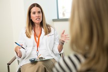 Nurse talking with patient about cancer survivorship