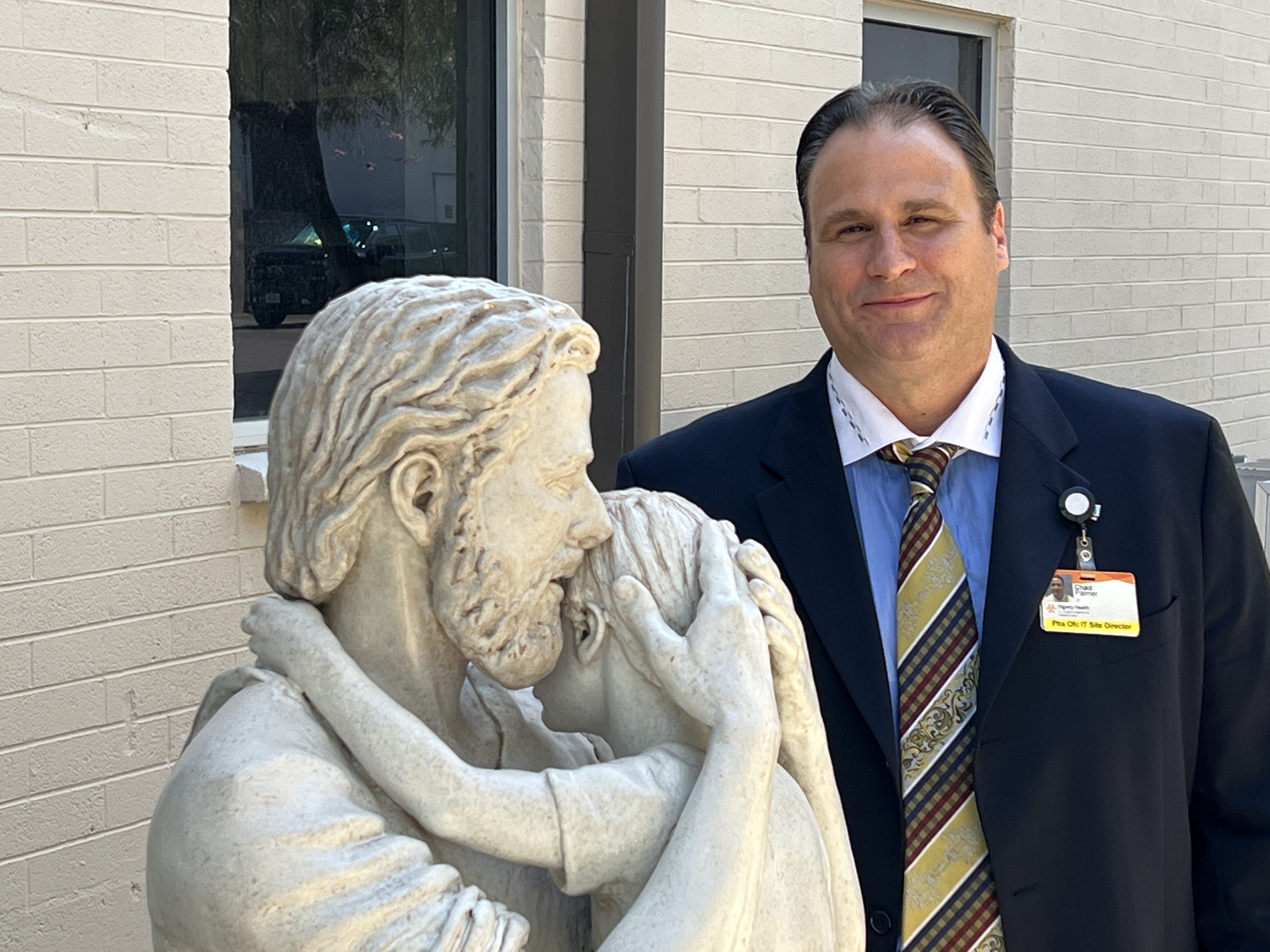 Chad Palmer standing next to a St. Joseph's statute