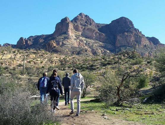 People hiking at base of mountain