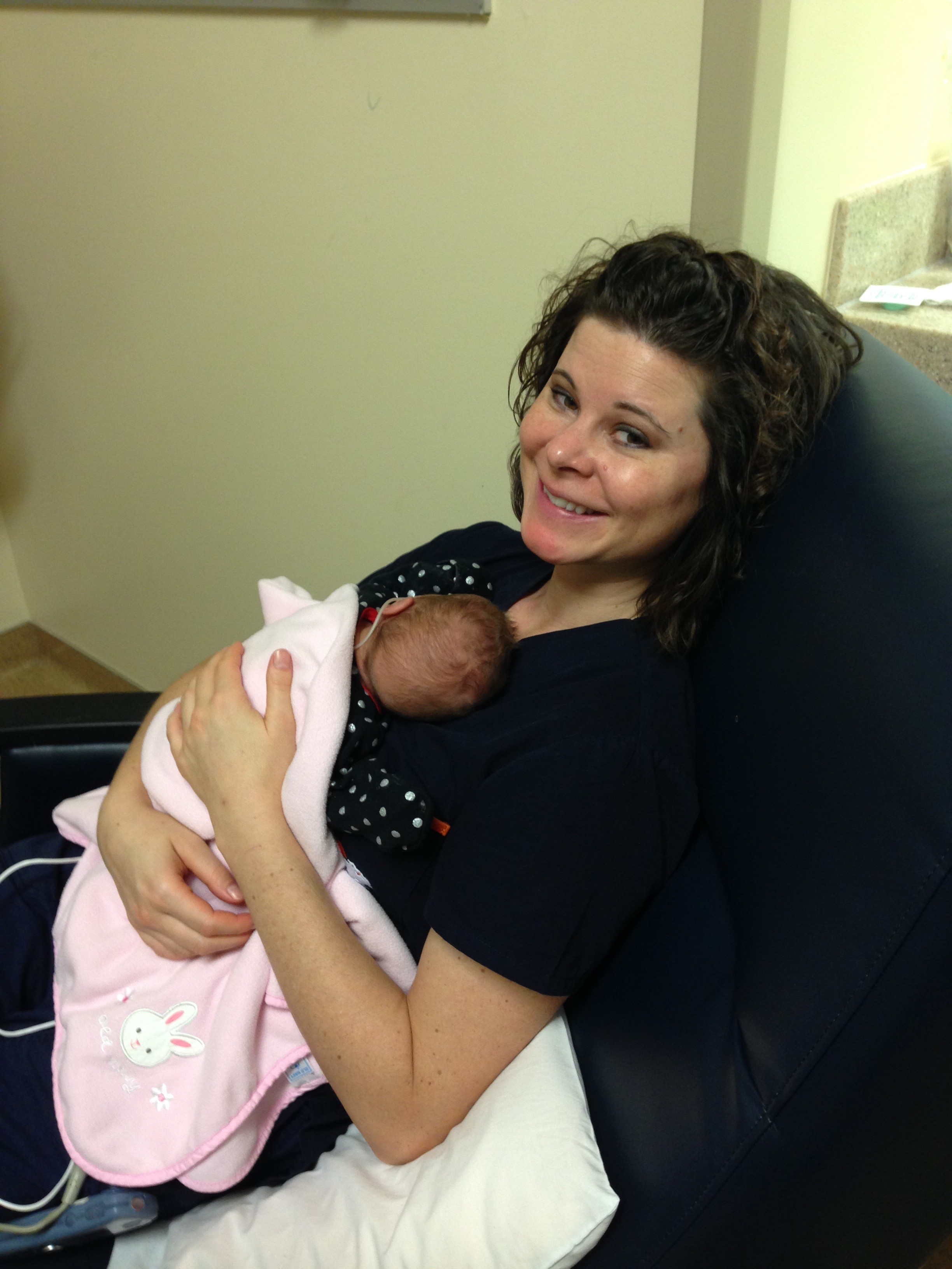 NICU nurse holding infant