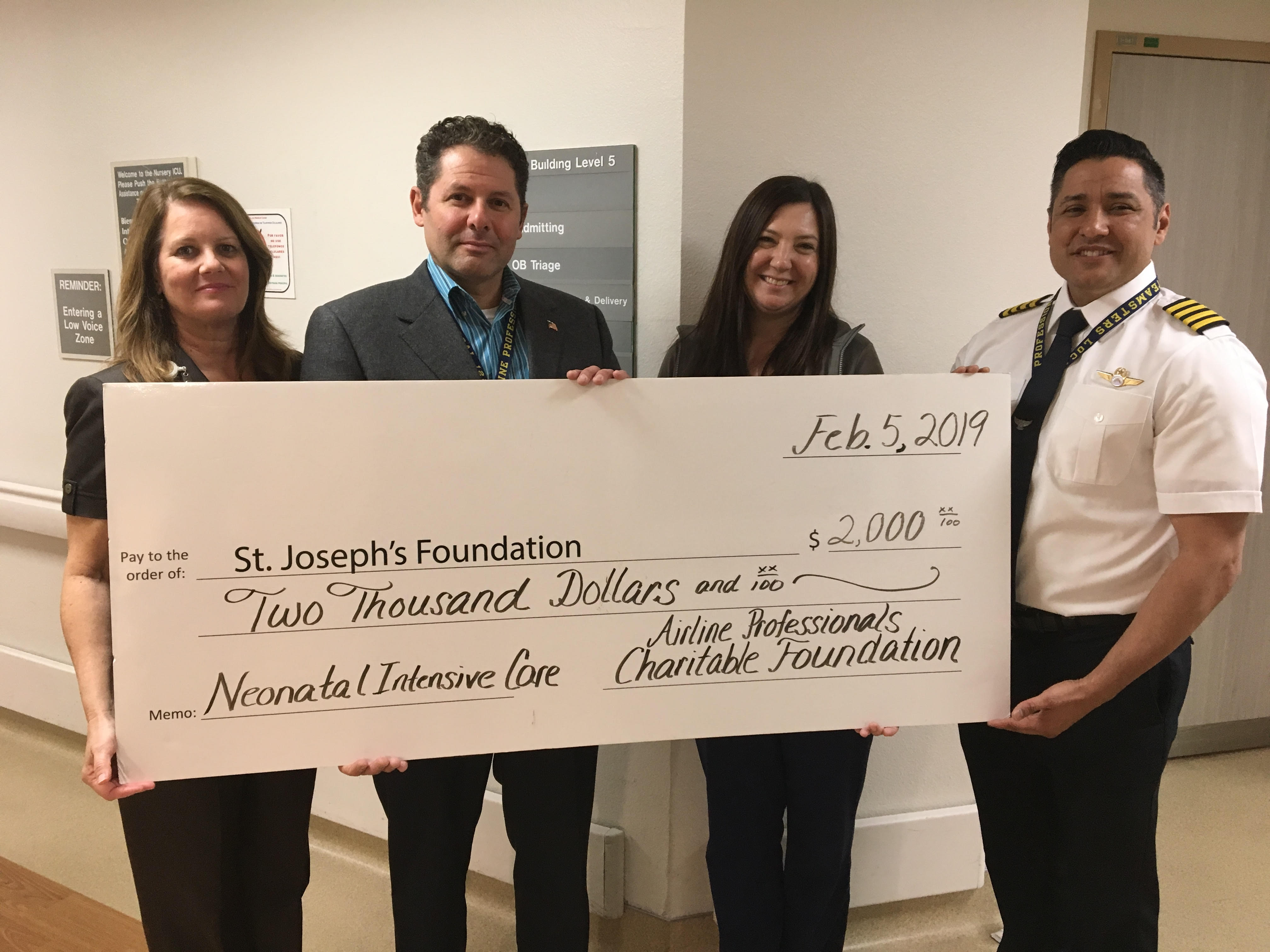 Pilots donate check to NICU nurse