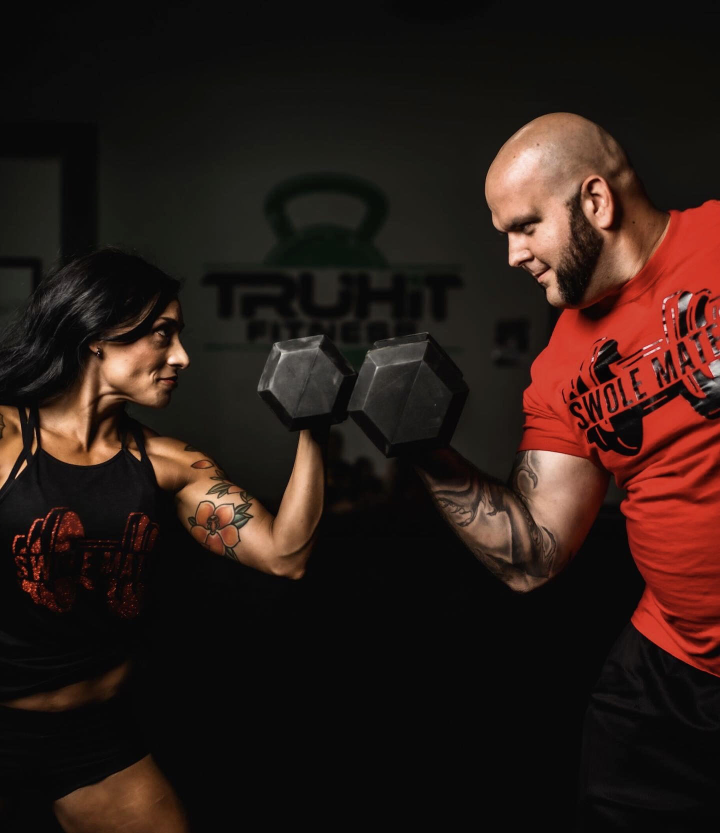 Husband and wife powerlifting weights together